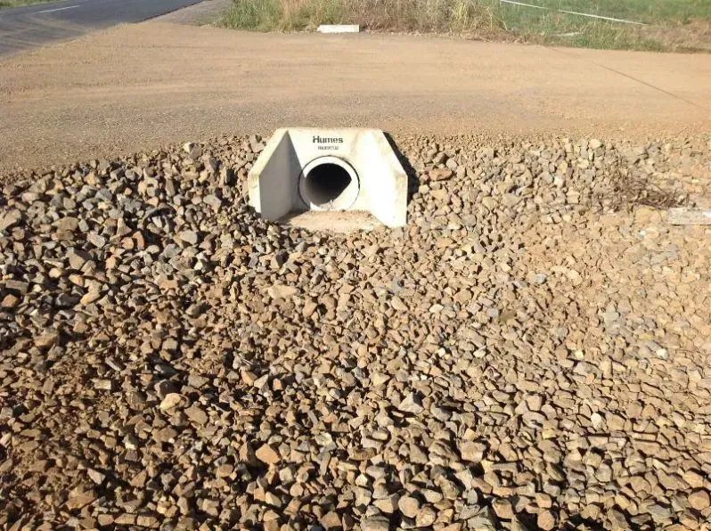 A Concrete Pipe is in the Middle of a Pile of Gravel — S M & A J Gilbert Earthmoving in Mitchells Island, NSW