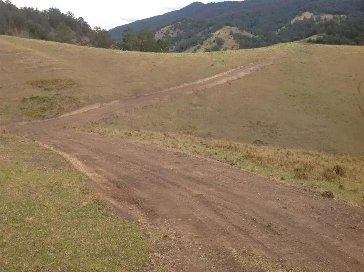 A Dirt Road Going Through The Mountains — S M & A J Gilbert Earthmoving in Mitchells Island, NSW