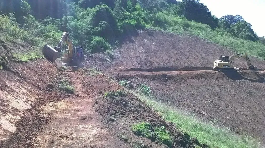 A Large Pile of Dirt is Sitting on Top of a Hill — S M & A J Gilbert Earthmoving in Mitchells Island, NSW