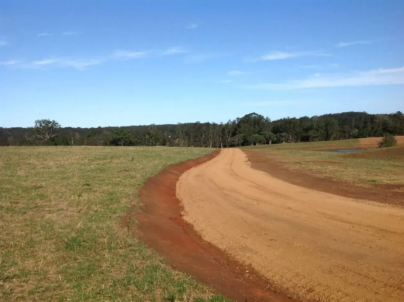 A Dirt Road Going Through a Sunny Day — S M & A J Gilbert Earthmoving in Mitchells Island, NSW