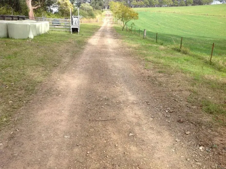 A Dirt Road Trail Going Through a Grassy Field — S M & A J Gilbert Earthmoving in Mitchells Island, NSW