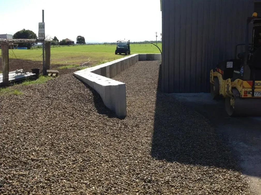A Yellow Forklift is Parked in Front of a Building — S M & A J Gilbert Earthmoving in Mitchells Island, NSW