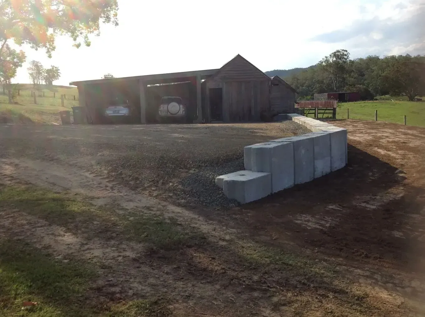A Concrete Wall is Being Built in Front of a Barn — S M & A J Gilbert Earthmoving in Mitchells Island, NSW