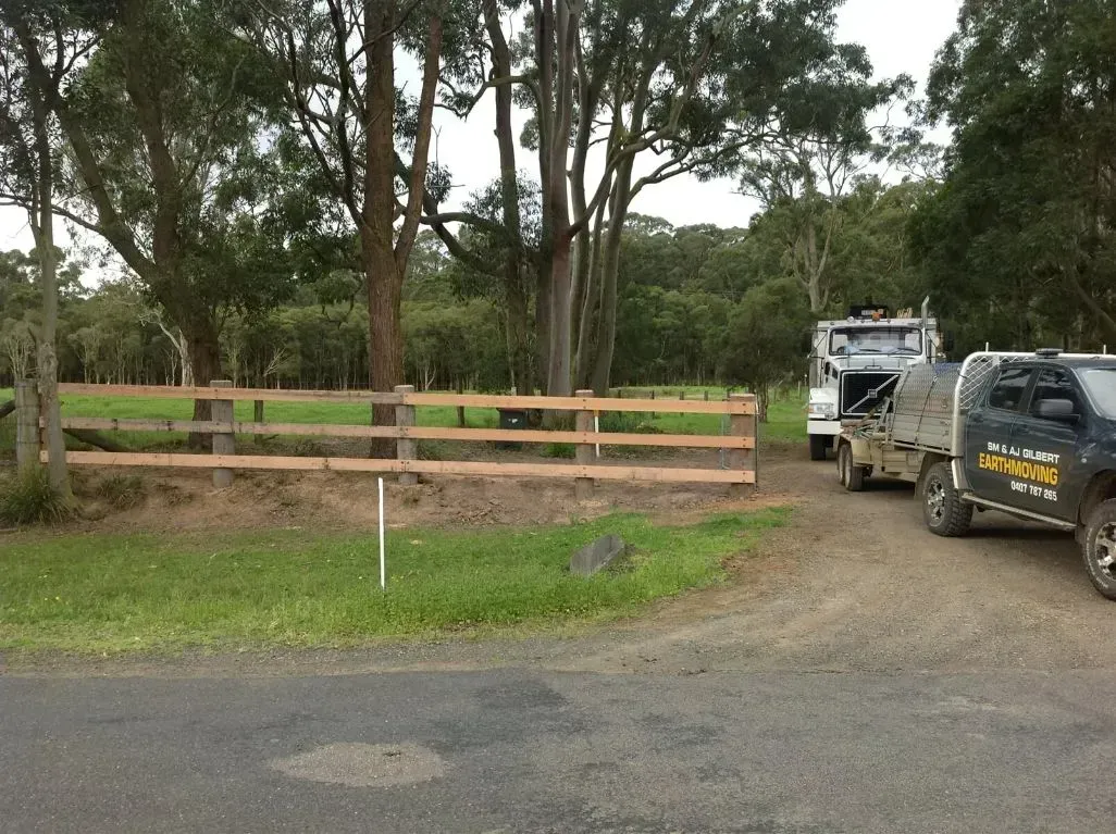 A Wooden Fence is in the Middle of a Forest — S M & A J Gilbert Earthmoving in Mitchells Island, NSW