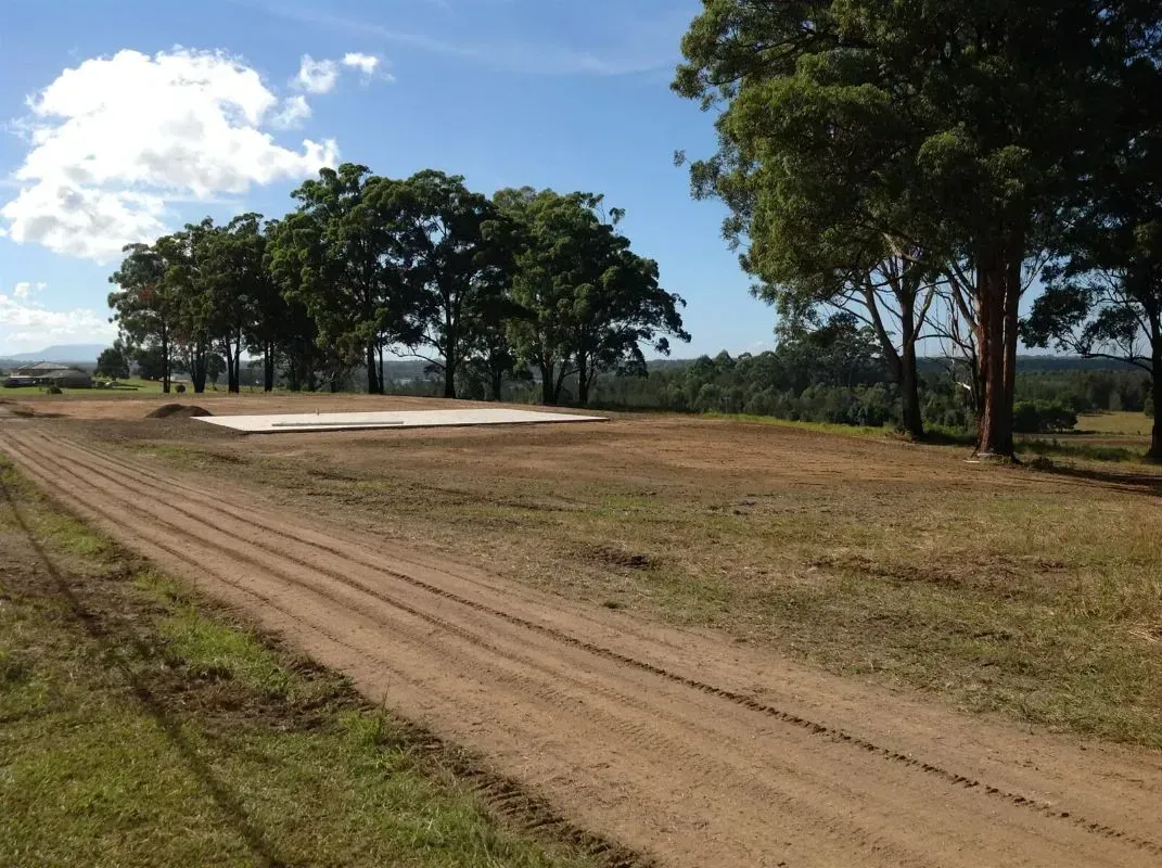 A Dirt Road With Trees on the Side of It With Blue Skies — S M & A J Gilbert Earthmoving in Mitchells Island, NSW
