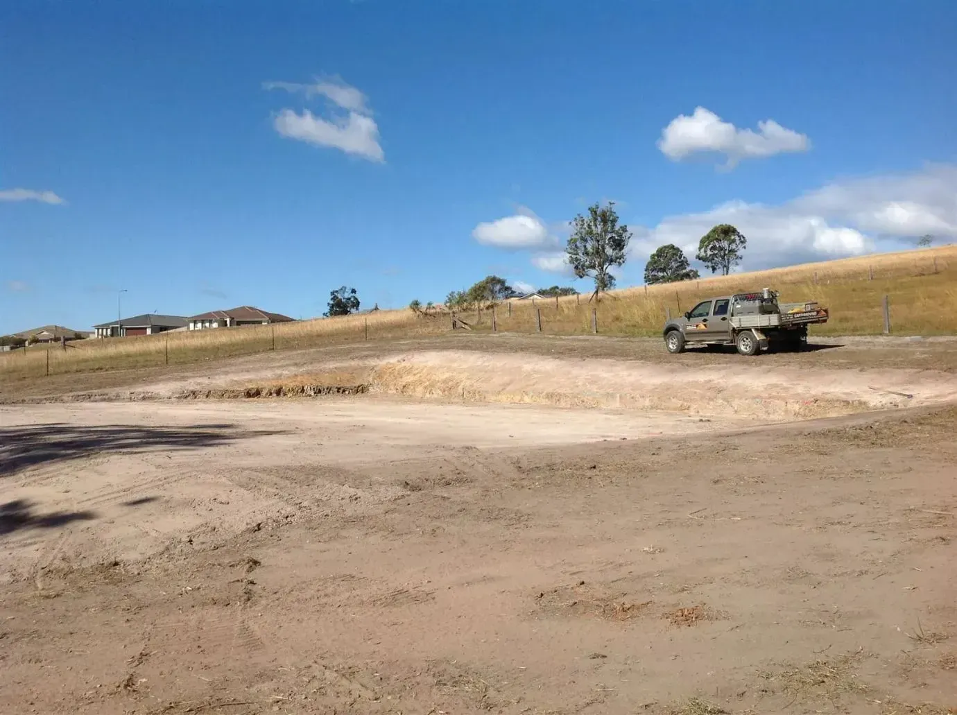 A Pickup Truck is Parked in the Middle of a Field — S M & A J Gilbert Earthmoving in Mitchells Island, NSW