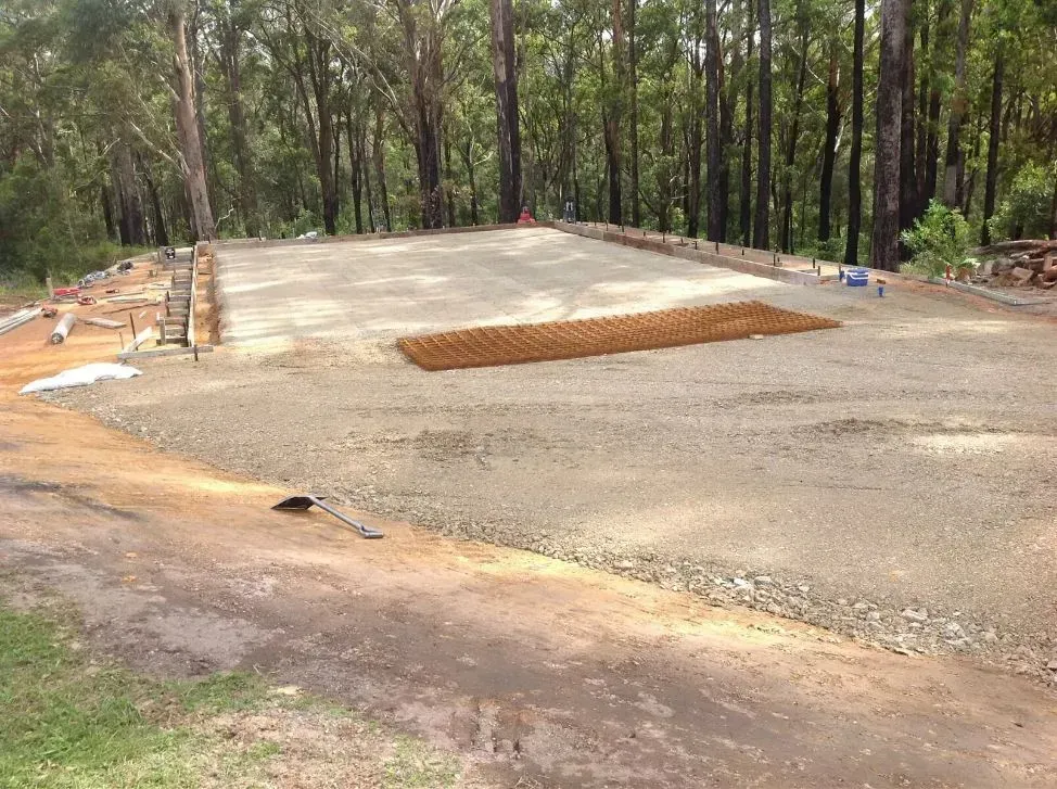 A Dirt Road Going Through a Forest With Many Trees in the Background — S M & A J Gilbert Earthmoving in Mitchells Island, NSW