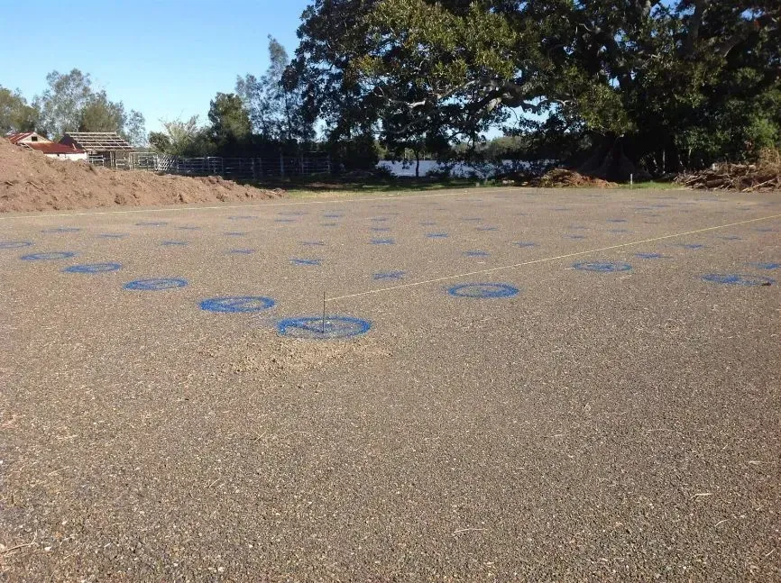 A Parking Lot With a Lot of Blue Circles on It — S M & A J Gilbert Earthmoving in Mitchells Island, NSW