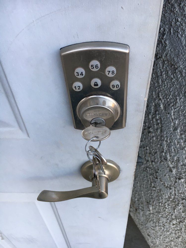 A close up of a door lock with keys on it.
