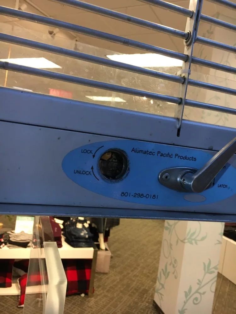 A blue fan is hanging from the ceiling in a room.