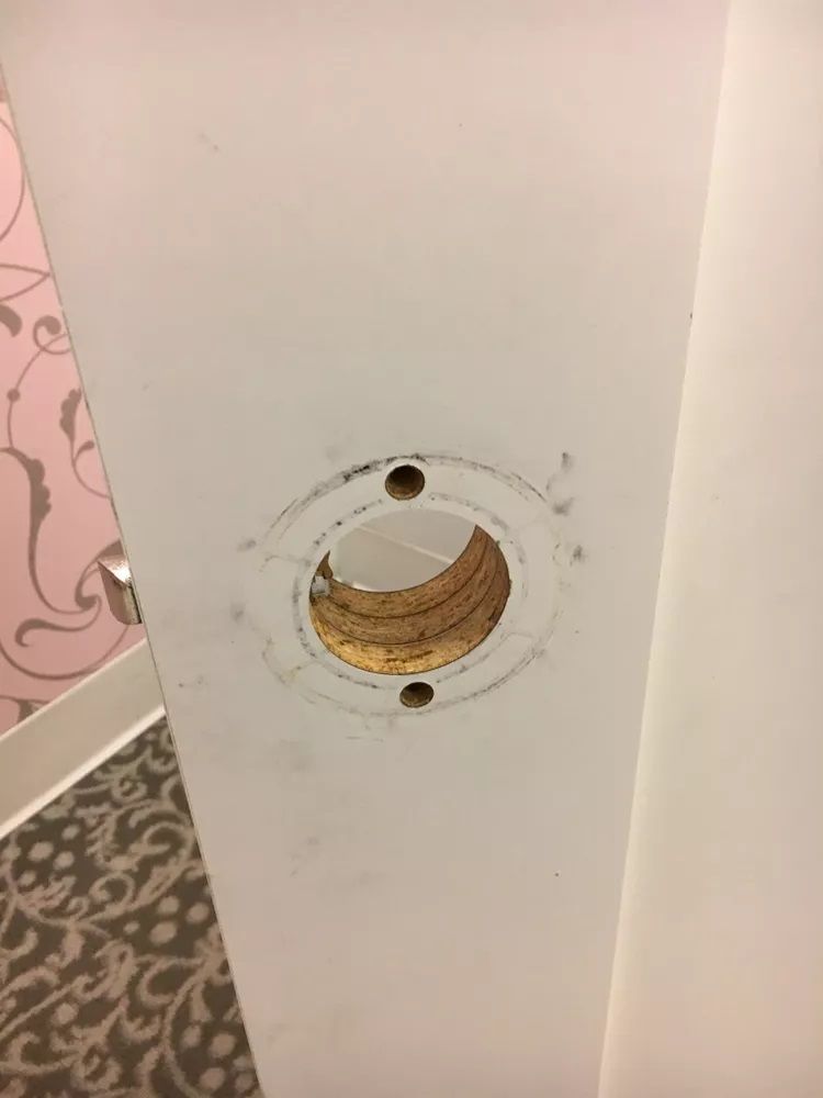 There is a hole in the wall that looks like a banana peel.