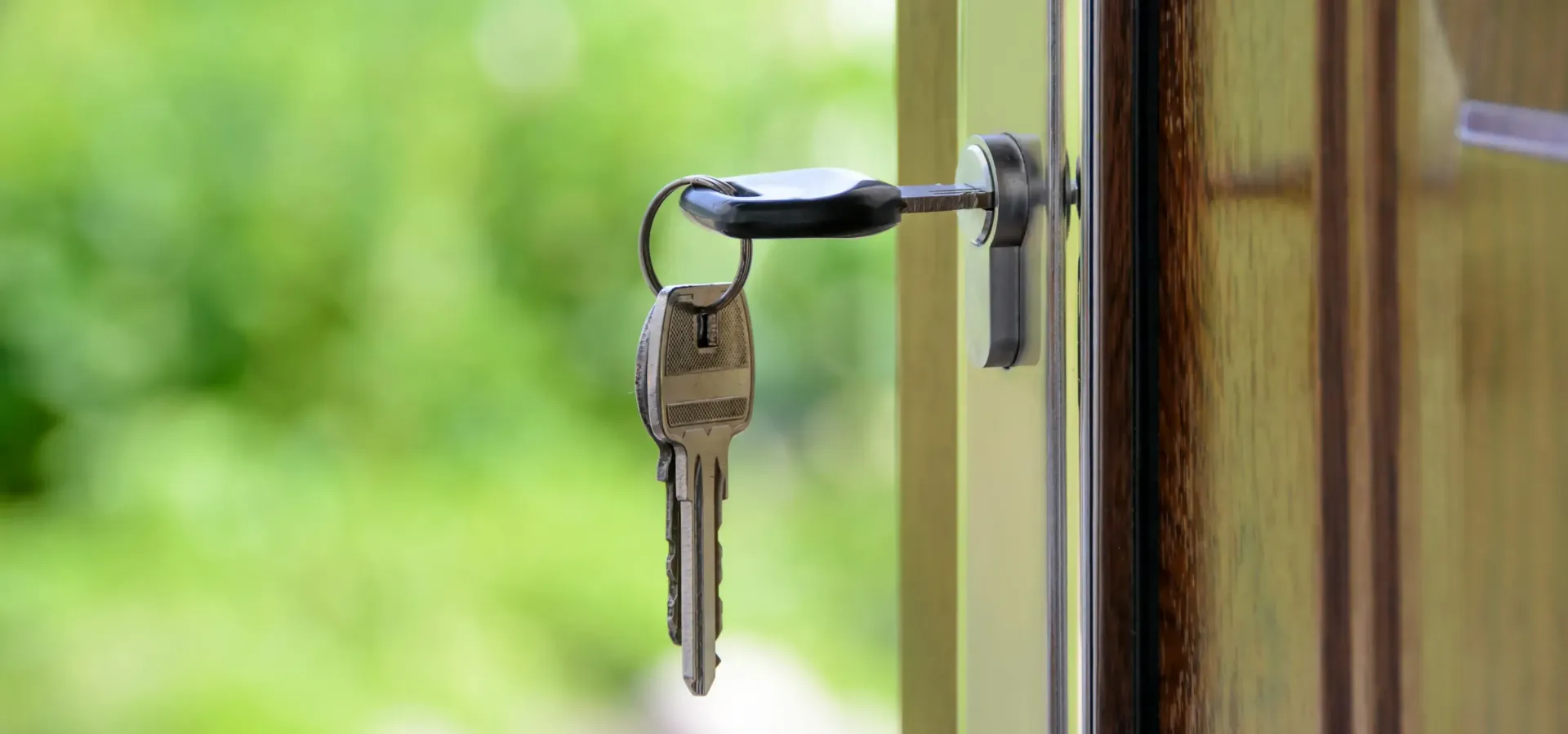 A close up of a door with keys in it.