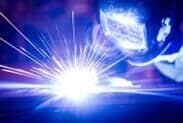 Employee welding at Mustang Fabrication, Inc. in Bellefonte PA