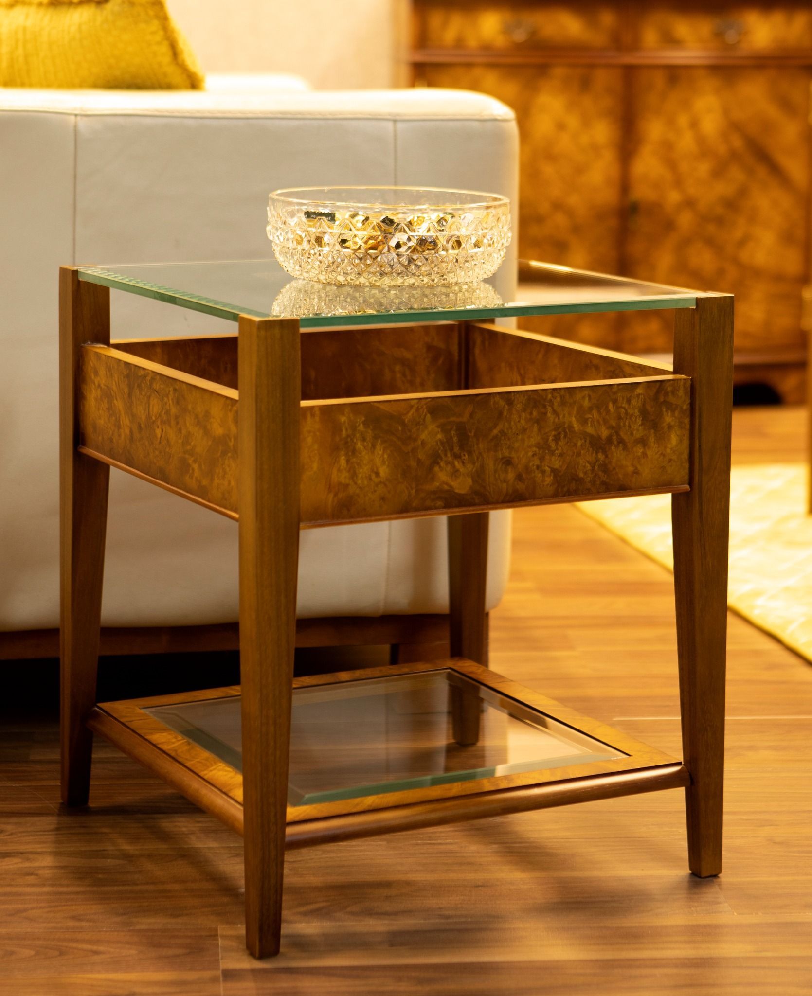 a small table with a glass top and a bowl on it