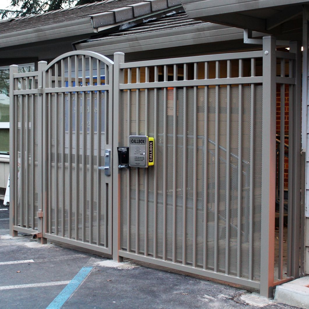 A gray fence with a yellow box that says ' emergency ' on it