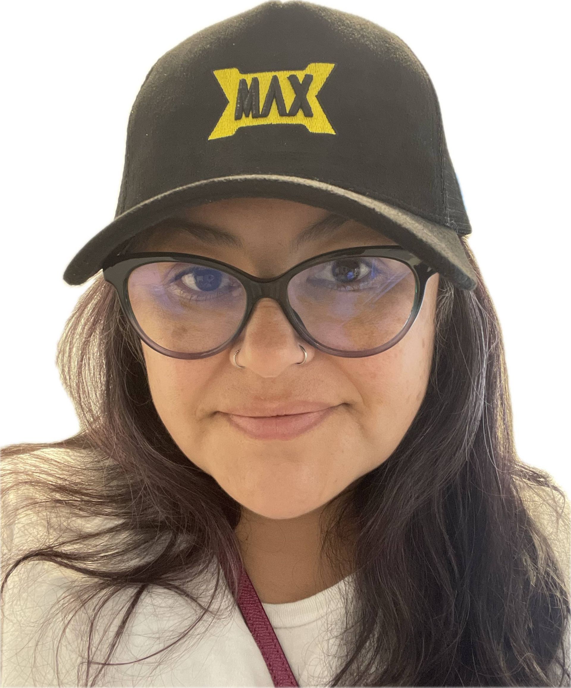 A woman wearing glasses and a black shirt is smiling for the camera.