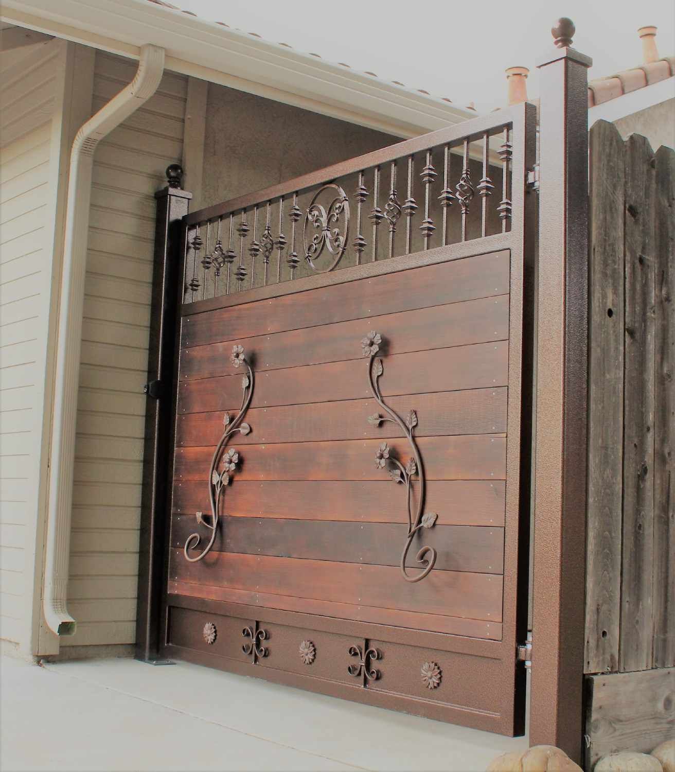 A wooden fence with a wrought iron railing