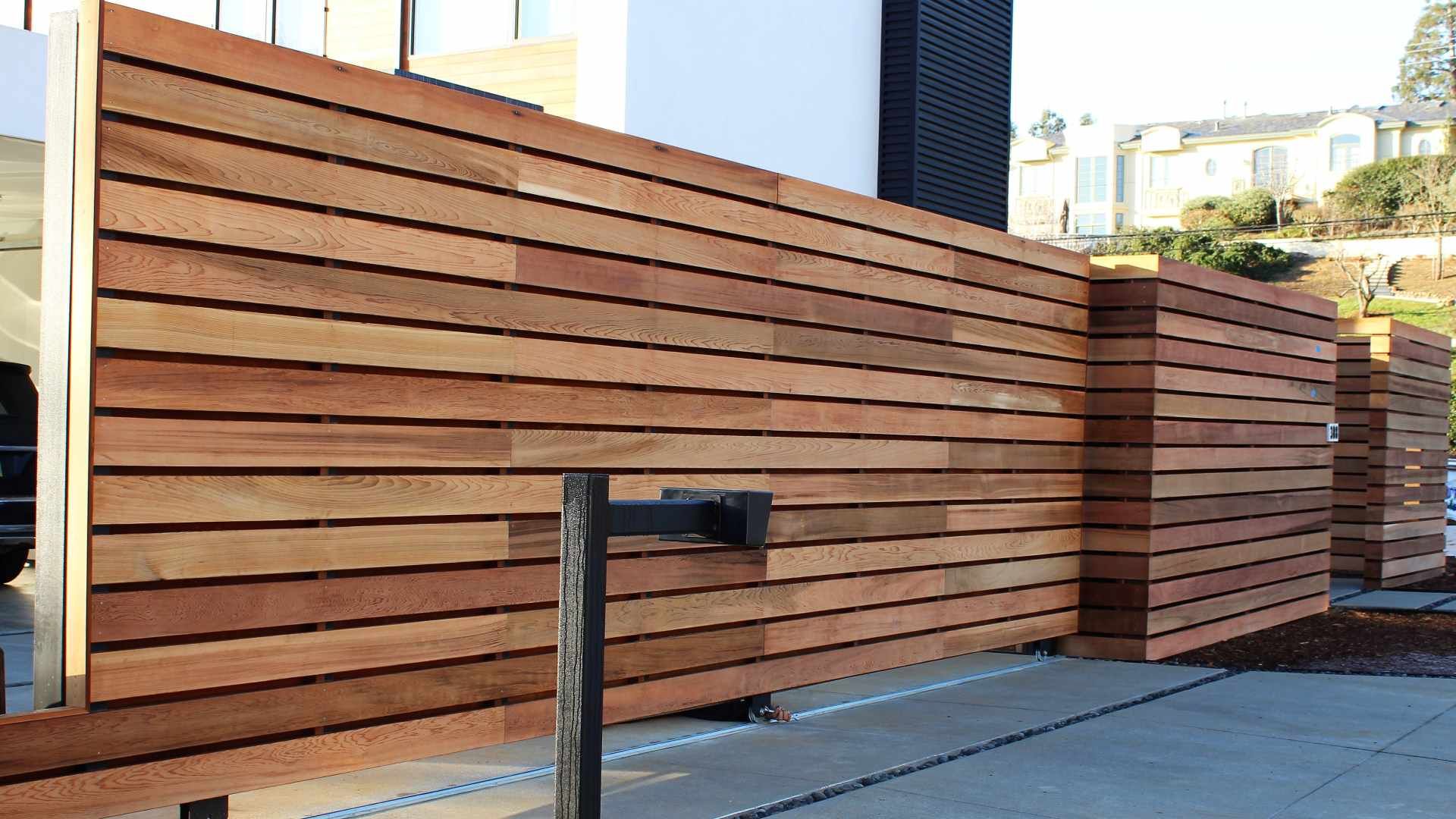 A wooden fence is being built in front of a house.