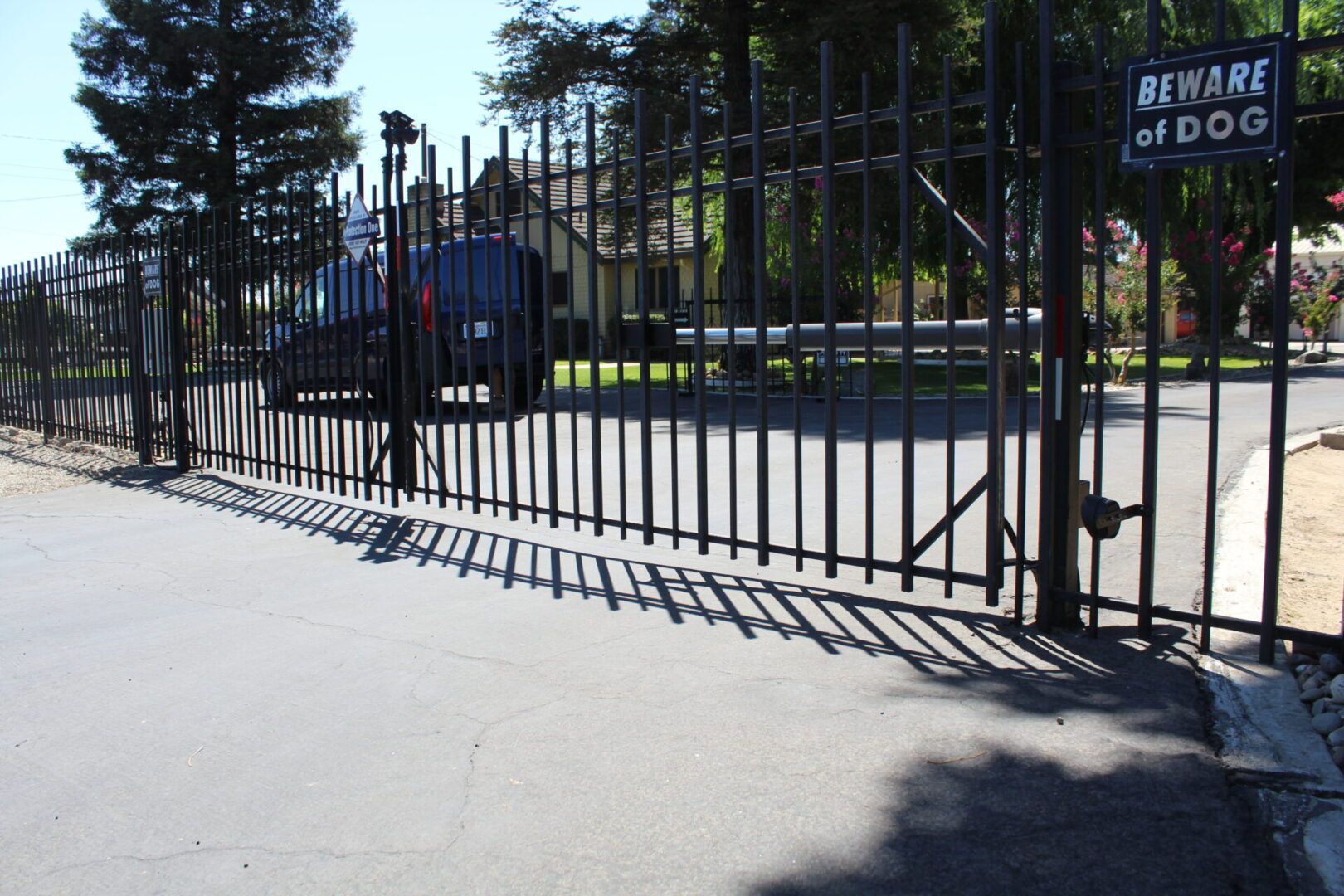 A fence with a sign that says beware of dogs