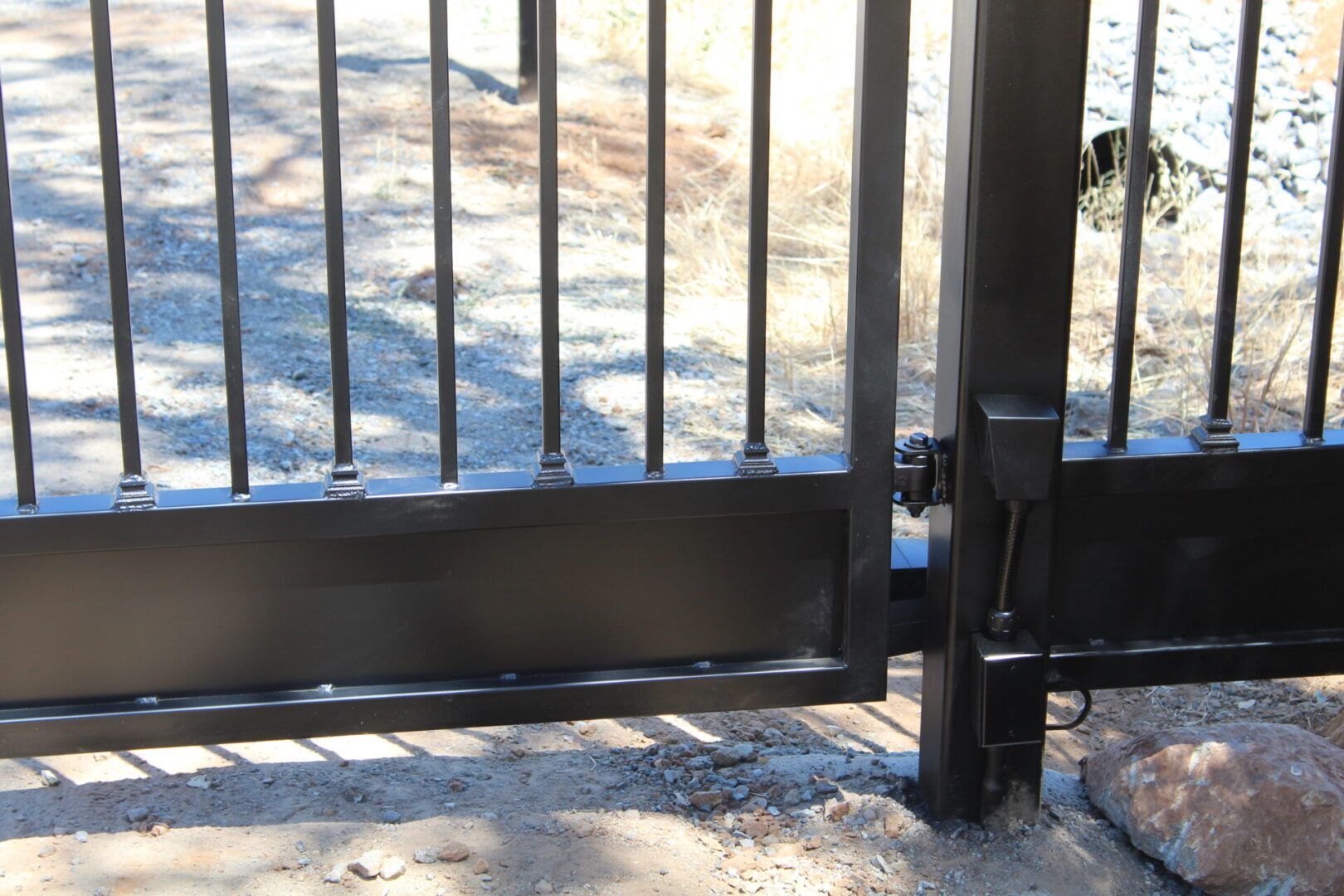 A close up of a black gate with a lot of bars