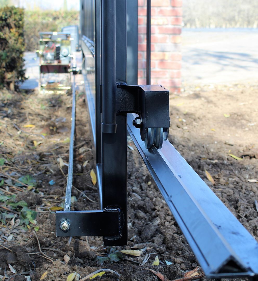 A close up of a sliding gate with wheels on it.