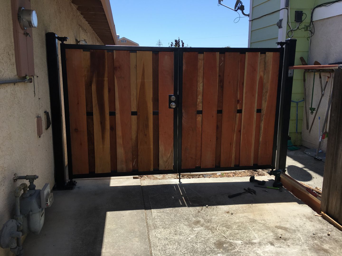 A wooden gate is sitting in front of a house