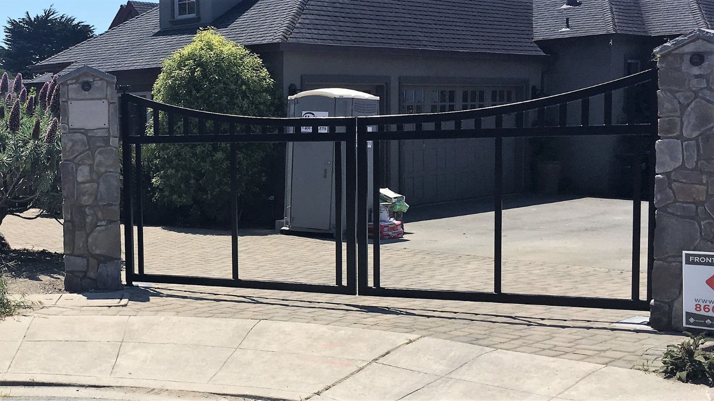 A large house with a large gate in front of it.