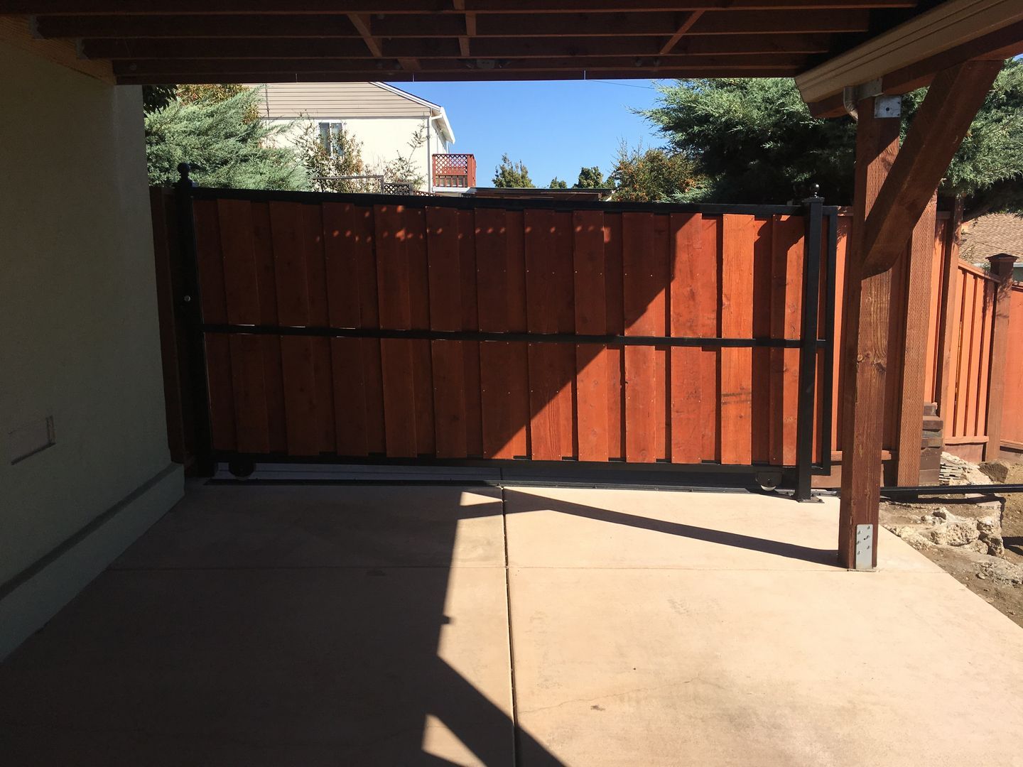 A wooden fence with a shadow on the ground