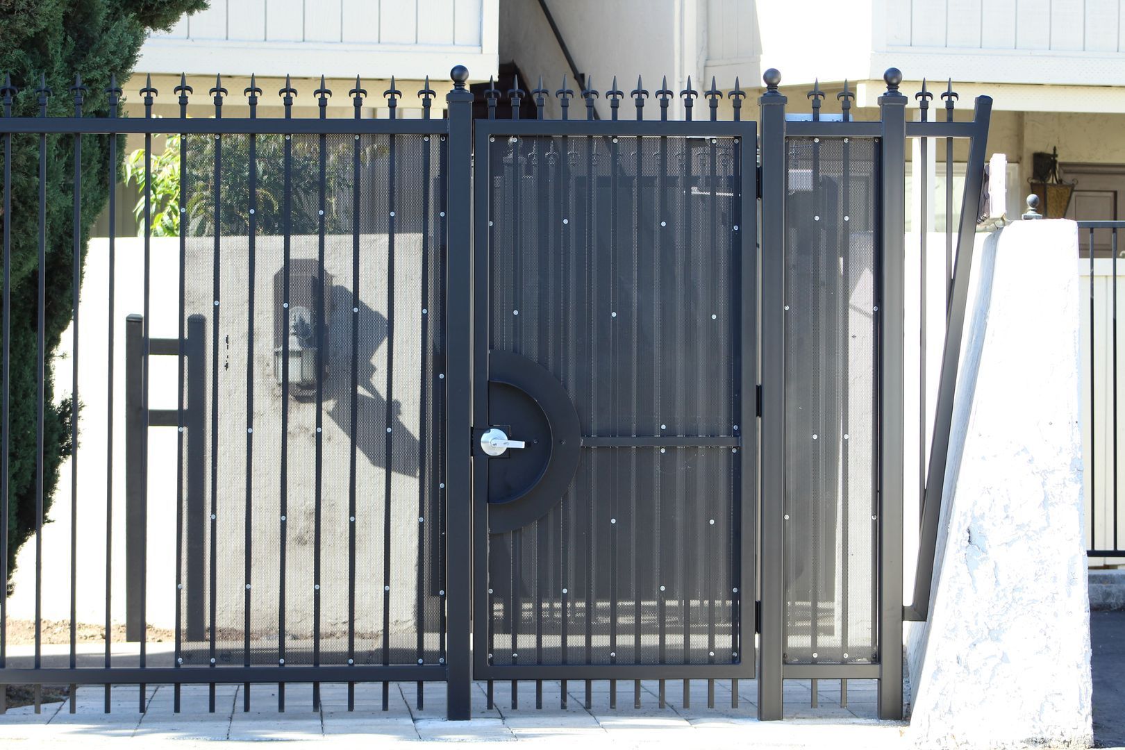 A fence with a tire in the middle of it