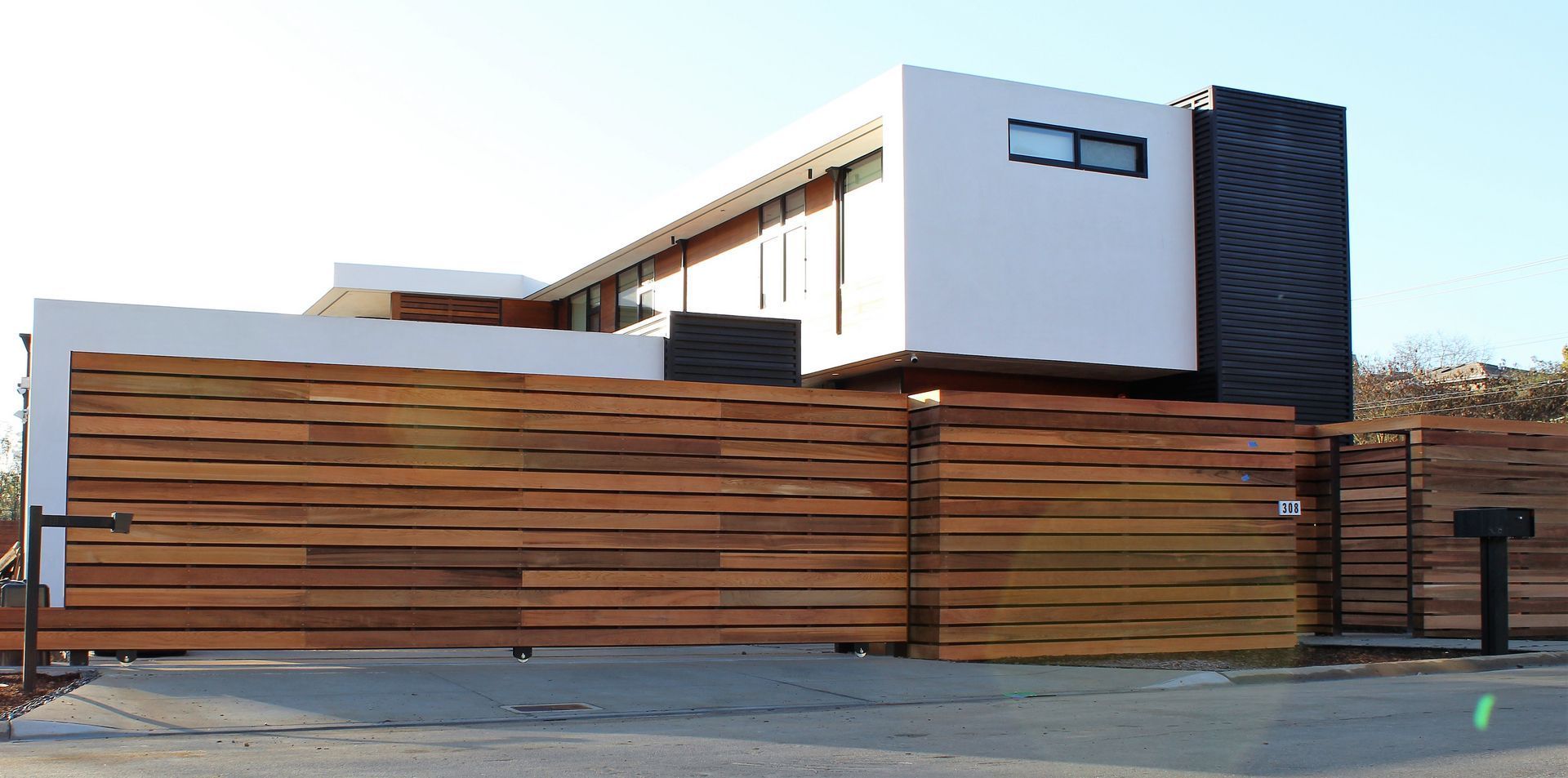 A white house with a wooden fence around it
