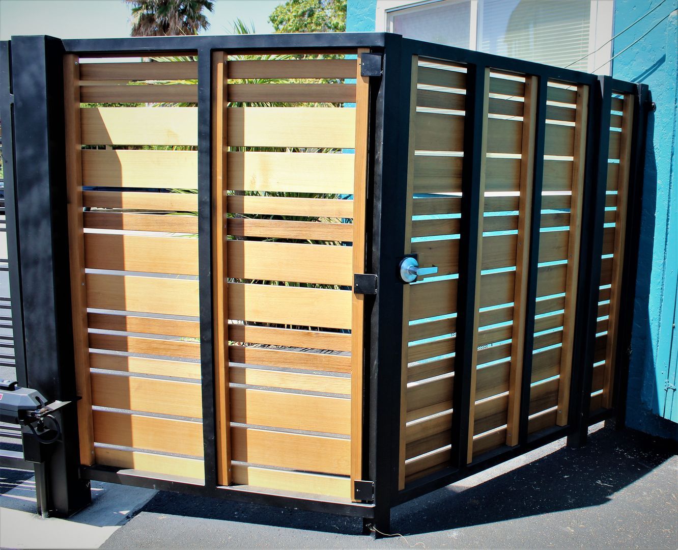 A wooden fence with a black metal frame