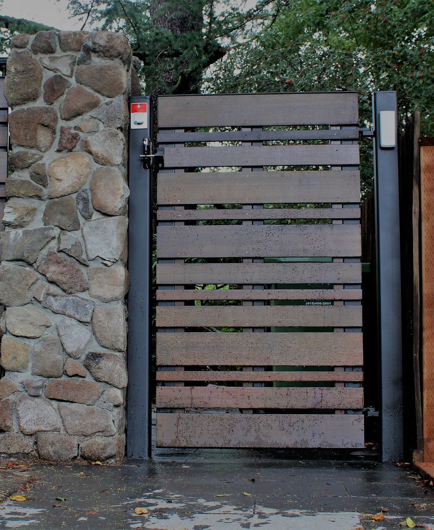 A stone wall with a wooden gate in front of it
