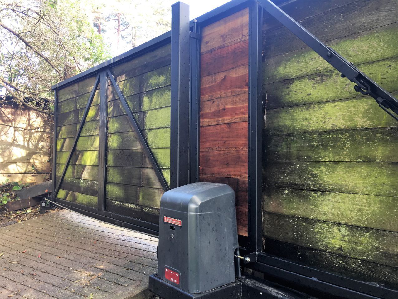 A sliding gate with a motor attached to it.