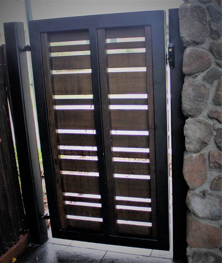 A stone wall with a wooden gate in front of it