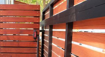 A close up of a wooden fence with a black frame.