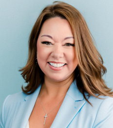 Woman with brown hair smiles, wearing a light blue blazer, against a blue background.