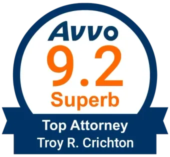 A badge that says AVVO 9.2 Superb Top Attorney Troy R. Crichton.