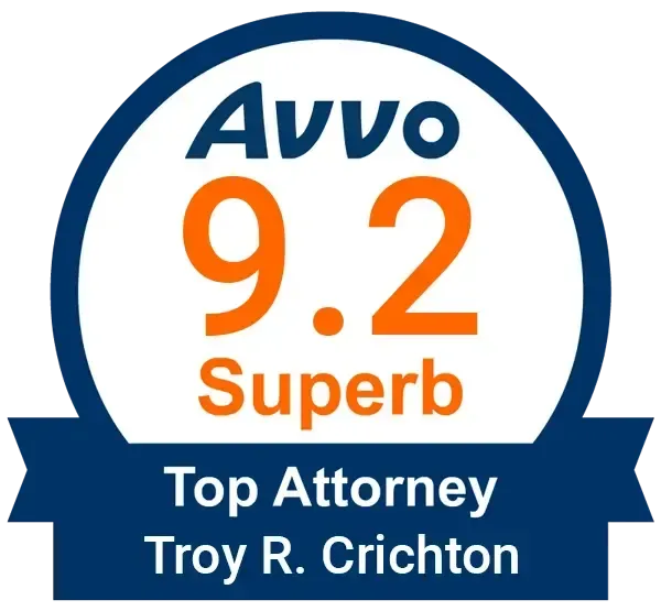 A badge that says AVVO 9.2 Superb Top Attorney Troy R. Crichton.