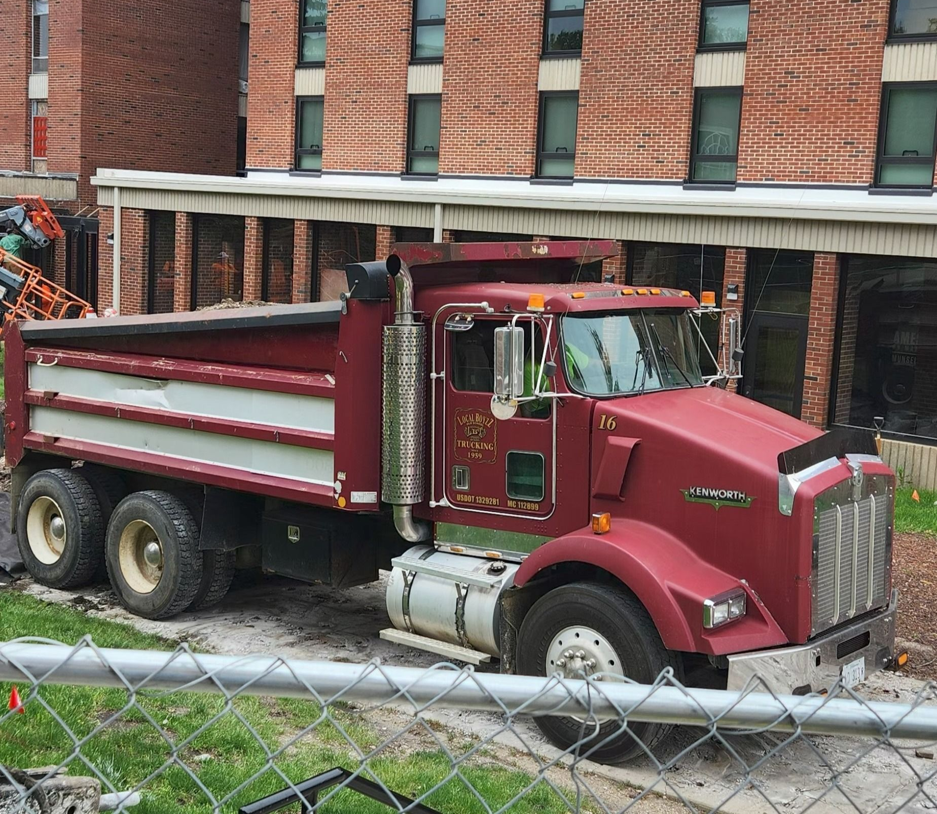 Truck hauling a large black pipes on highway Truck hauling a large black pipes on highway