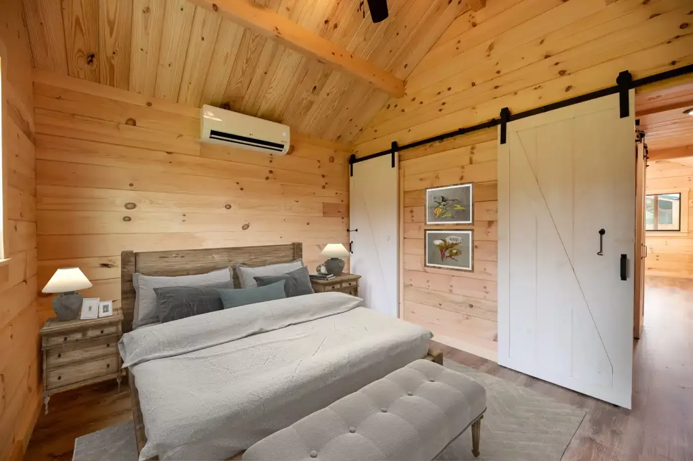 a bedroom with a large bed and sliding barn doors