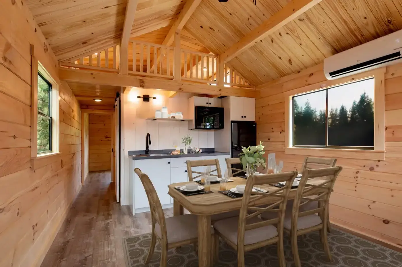 a wooden cabin with a dining table and chairs