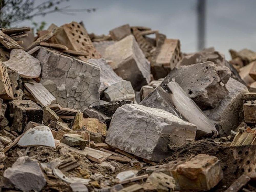 A pile of rocks and bricks on the ground.