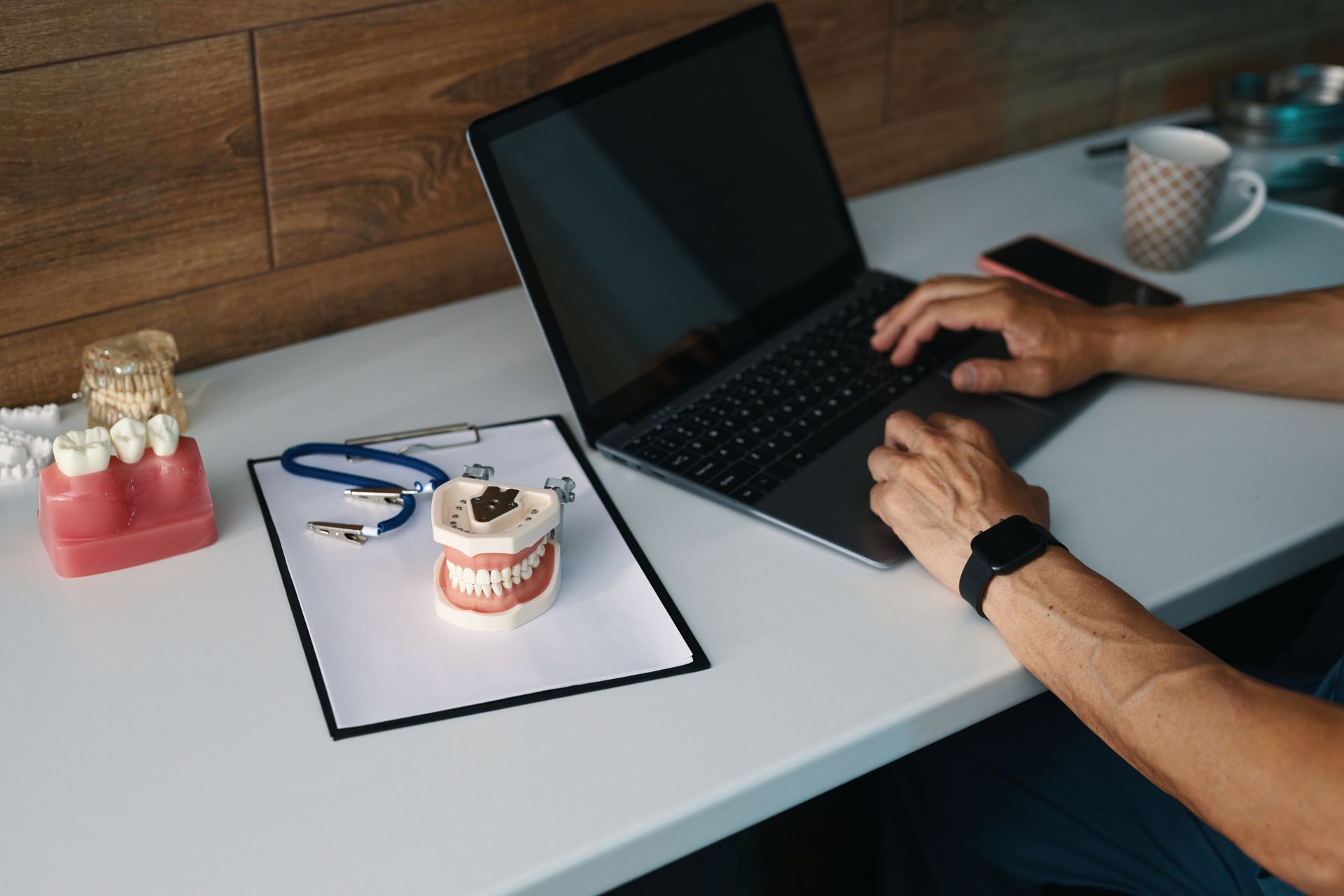 Person typing on laptop with Pro-Fi 20/20 Dental CPAs in Suwanee, GA 30024