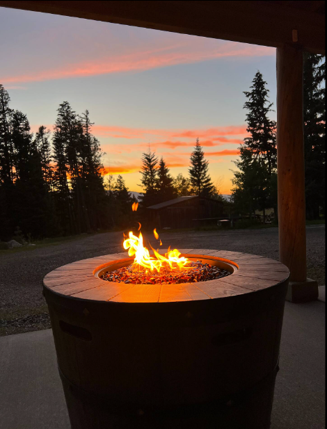 A fire pit with a sunset in the background