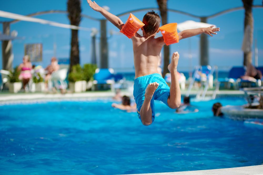 Young Boy Jumping Into Water Park