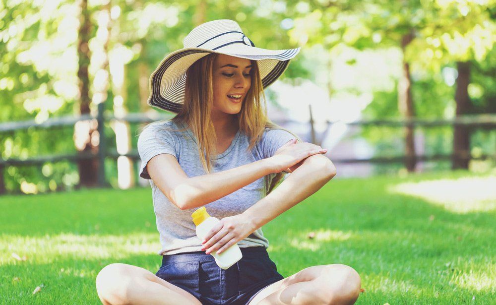 Young Woman Applying A Sunscreen — The Big Buzz Fun Park Pty Ltd in Rainbow Flat, NSW
