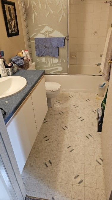 A bathroom with a toilet , sink , shower and bathtub.