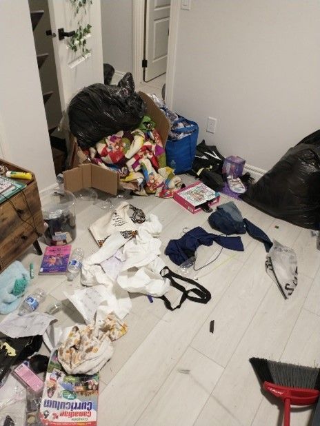 A messy room with a box that says curriculum on it