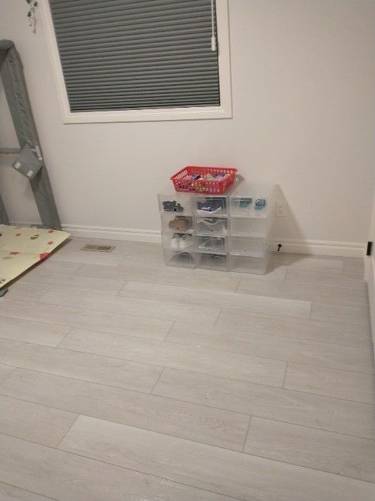 There is a basket on the floor in the middle of the room.