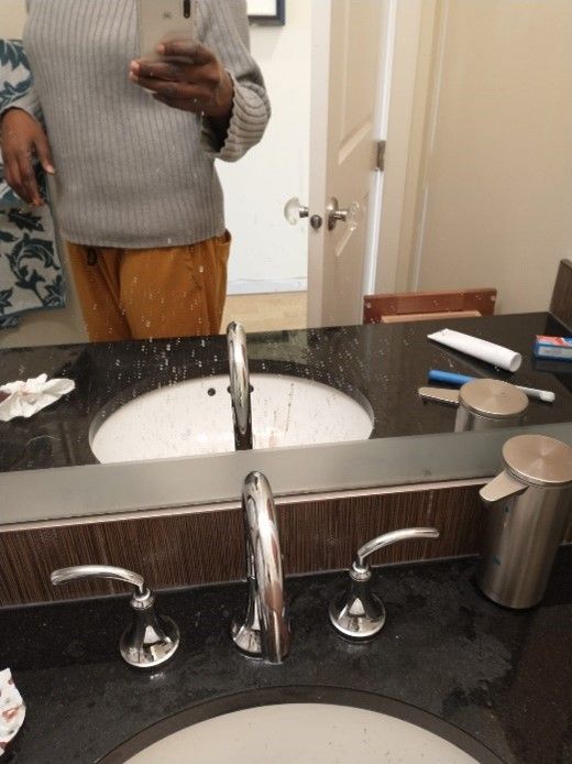A man taking a picture of himself in a bathroom mirror